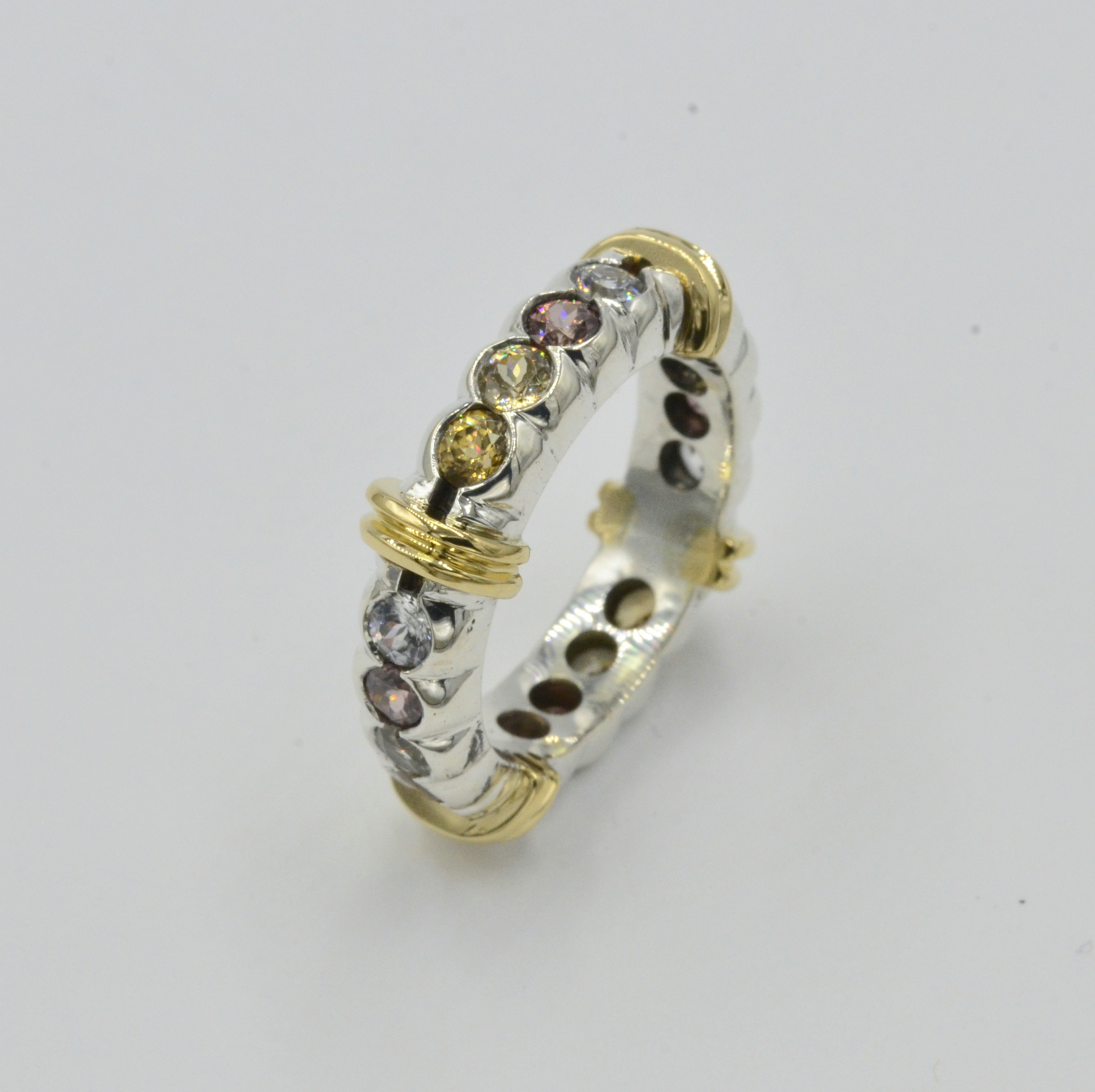 Eternity Style Ring. The Zircons color range from  Champagaine,Light Yellow and Copper.Ring Size is 6.75. Can be remade to accomodate a specific ring size. Please call for estimate
